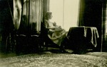 Photograph of Elisabeth Wolff sewing by a window, undated